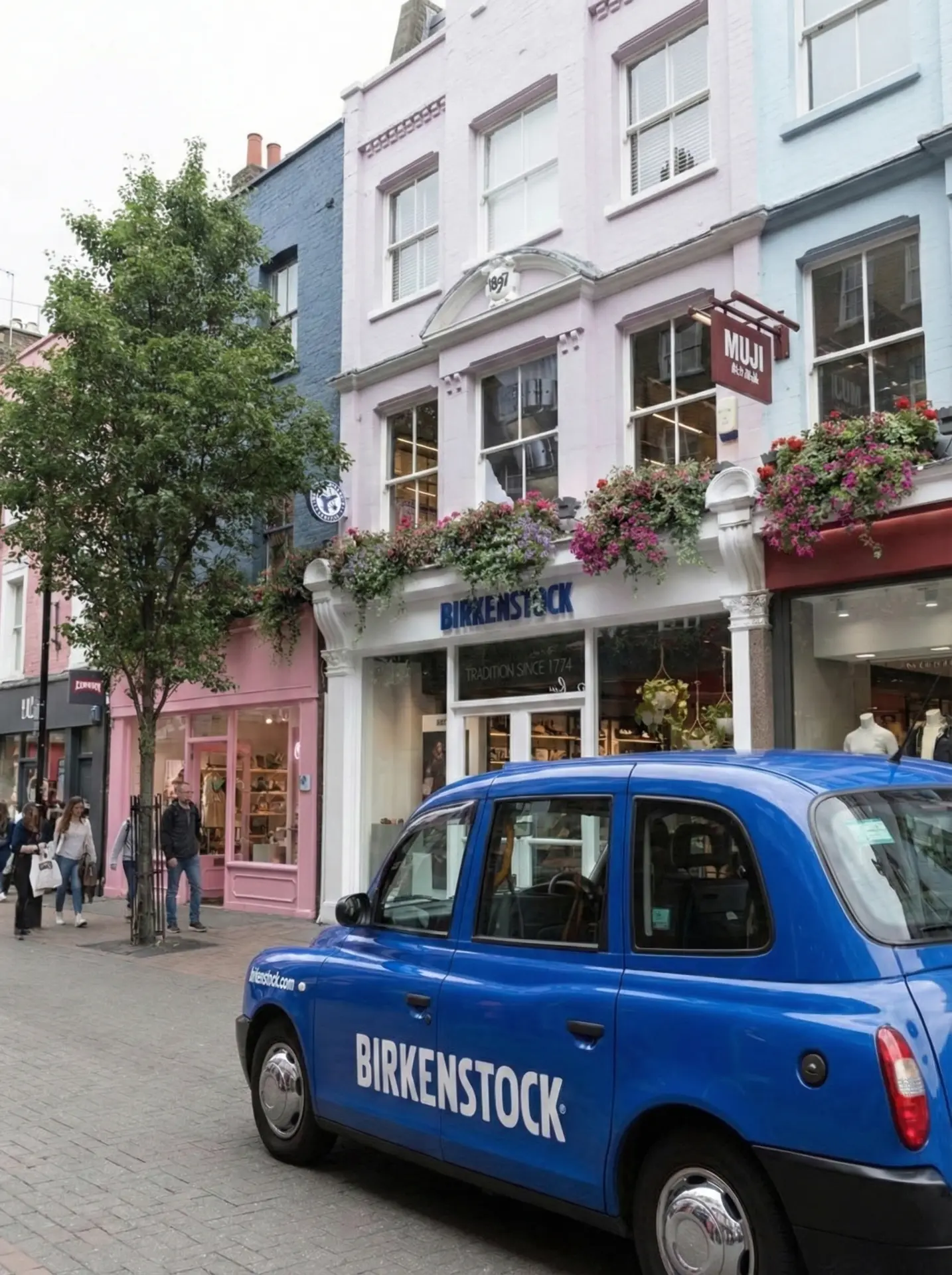 Birkenstock Carnaby Street storefront in London with the blue Birkenstock taxi.